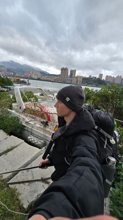 Following the river toward Bali district, fishermen along the banks, a cape on my shoulders, setting up camp for the night.