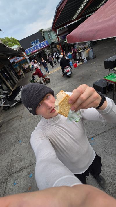 Eating a Zheng Dian Milk King cookie ice cream sandwich — so good.