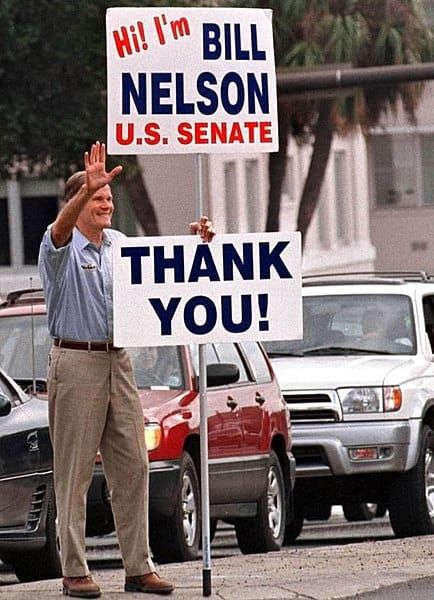 Senator Bill Nelson holding a 'Thank You!' sign. 