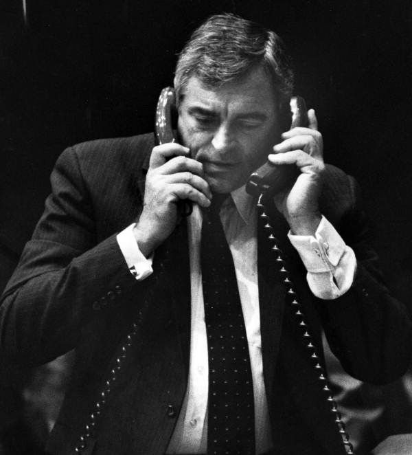Florida State Senator Tom McPherson talks on two rotary phones. 