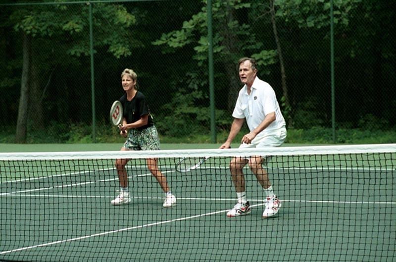 President George H. W. Bush playing tennis with Chris Evert. 