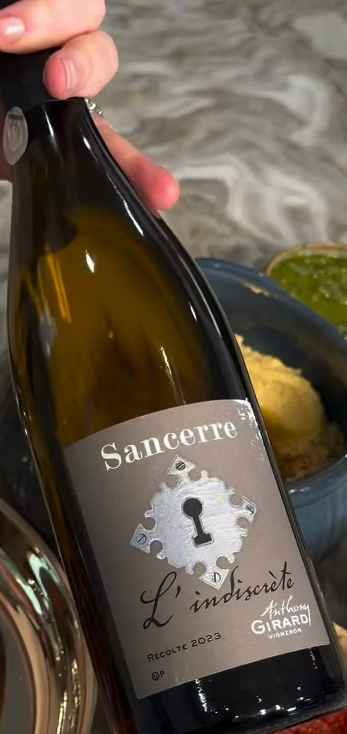 Anne holding a bottle of Anthony Girard L'Indiscrète Sancerre 2023, front label