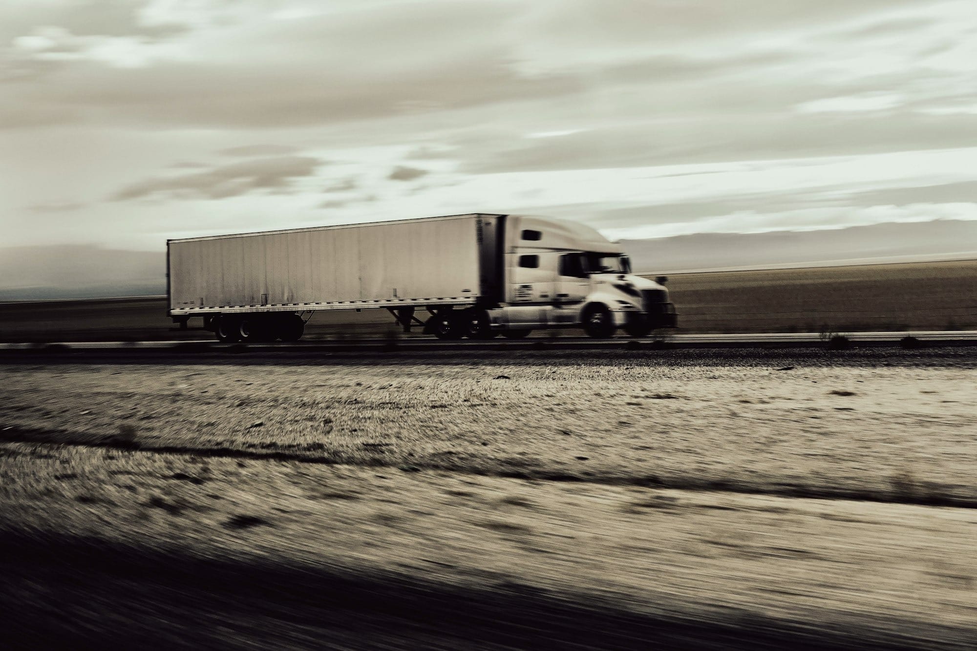a large semi truck driving down a highway