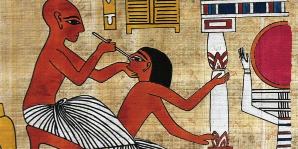 Ancient Egyptian wall painting showing a healer examining and treating an injured person.