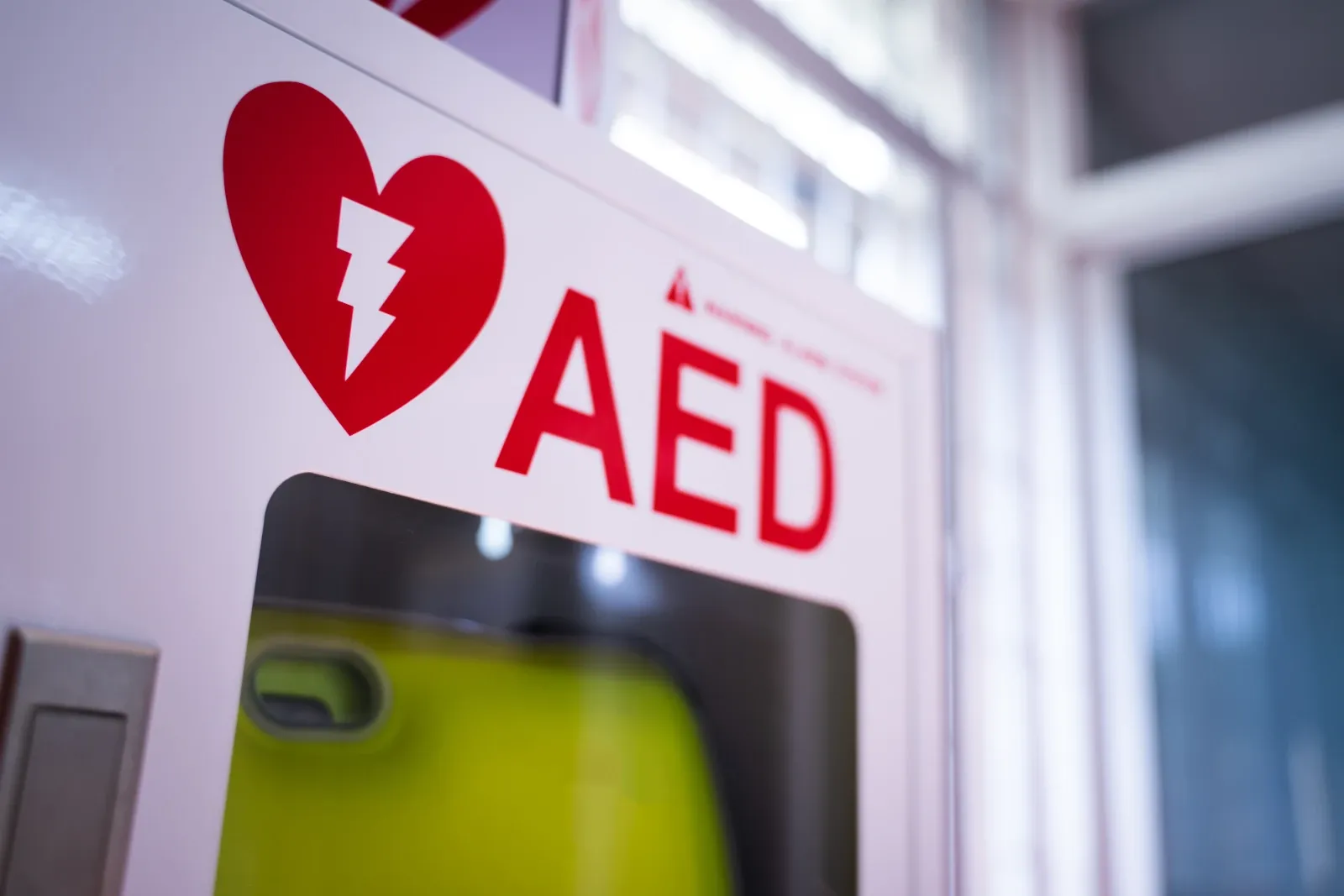AED cabinet with a defibrillator available for emergency use.