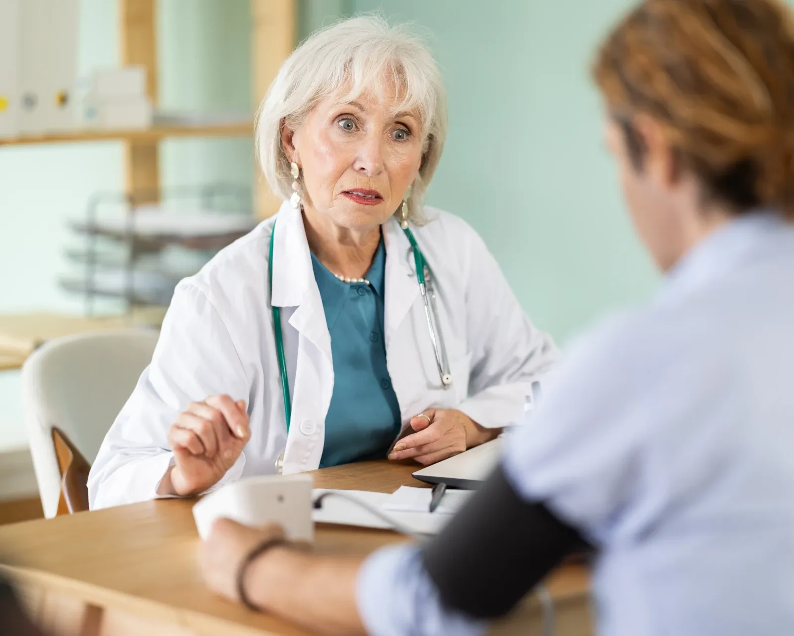 Doctor carrying out a physical health consultation and blood pressure check