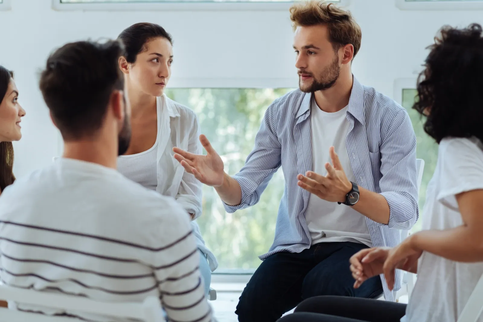 Colleagues taking part in a workplace group discussion about mental health