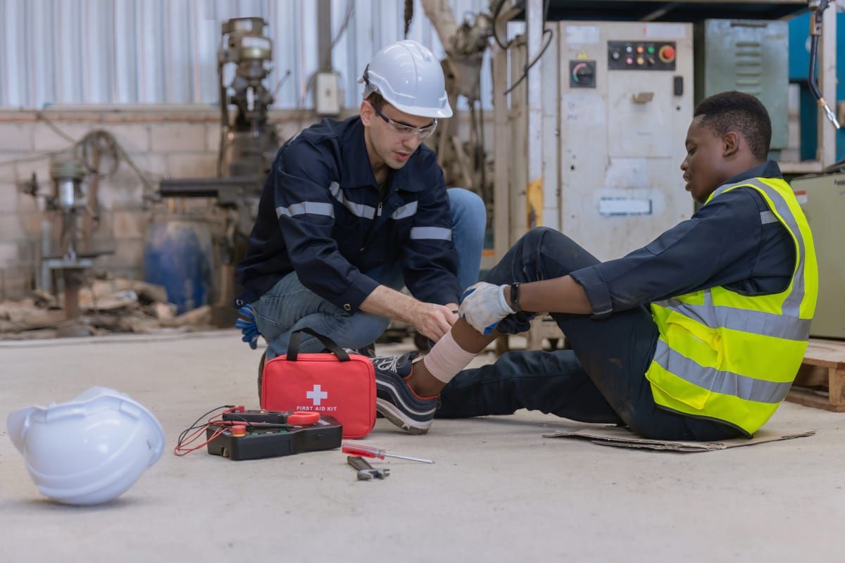 First aider providing calm, practical support to a colleague after a workplace injury
