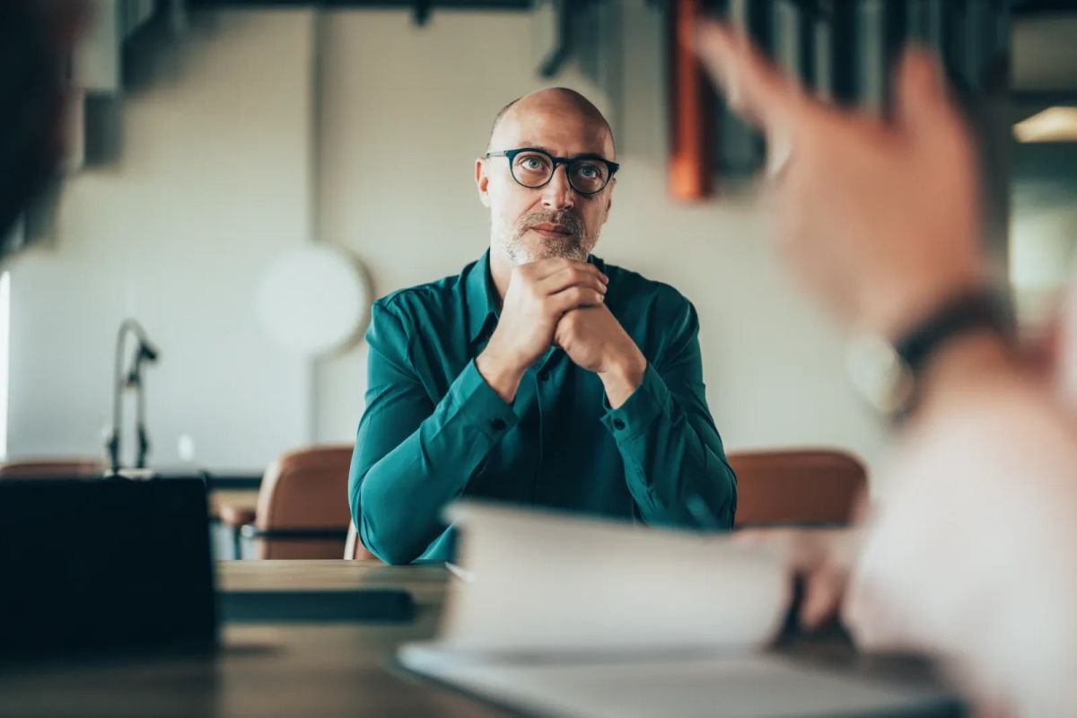 A manager listening during a private workplace conversation.
