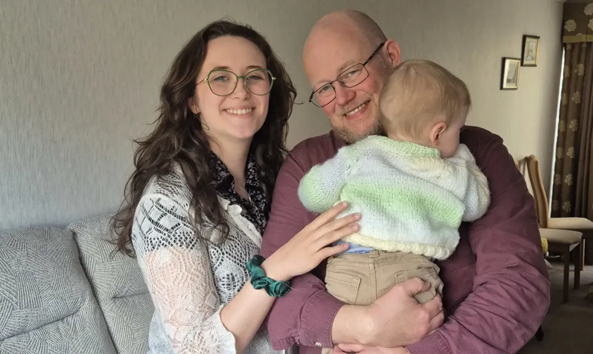 A father at home with his daughter and young son.
