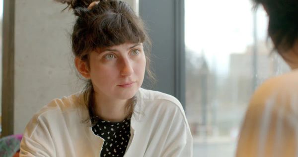 A colleague listening during a private one-to-one conversation.