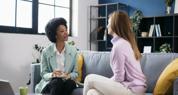 Manager listening to an employee during a private workplace conversation.