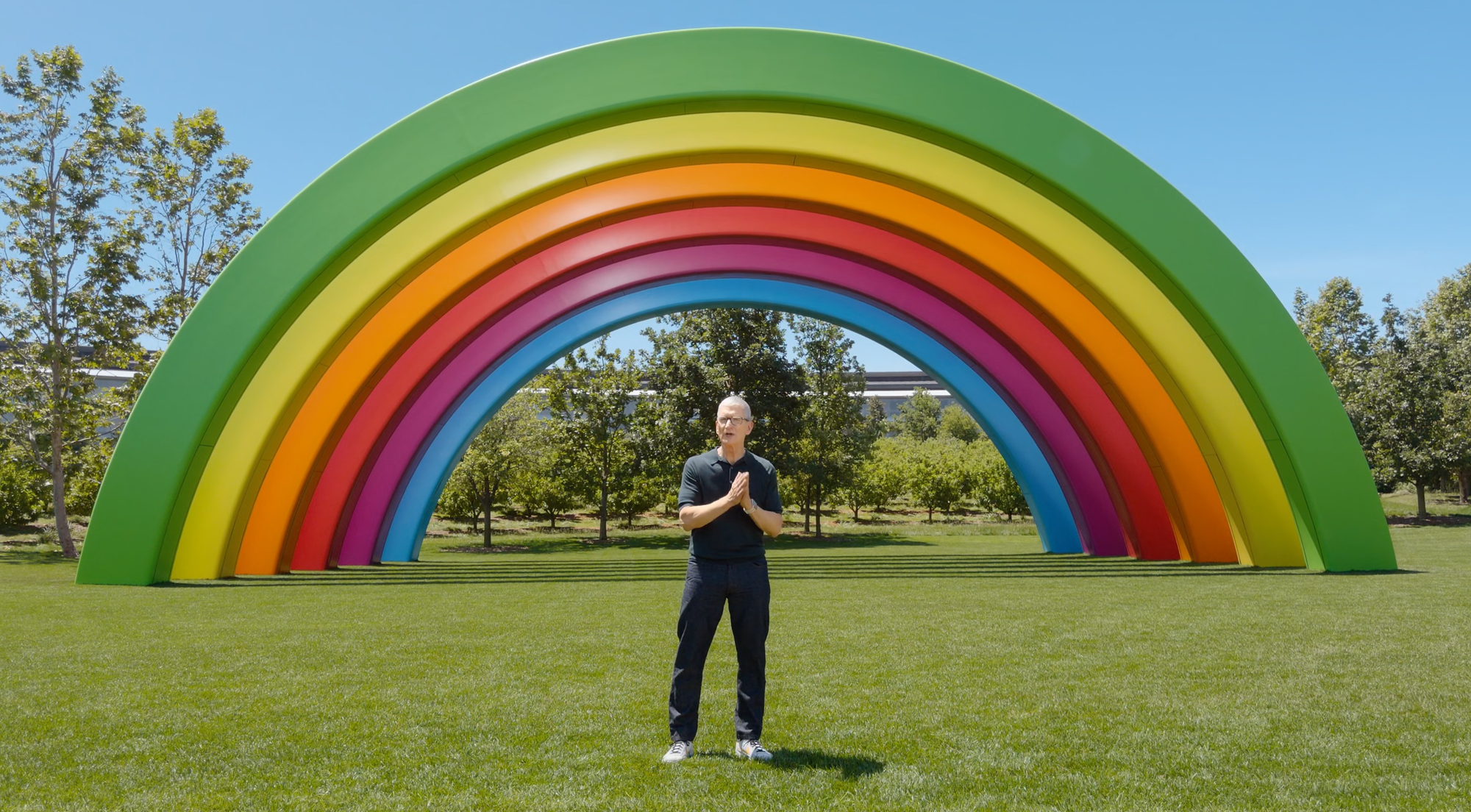 Screengrab of Tim Cook standing in front of the rainbow at Apple Park