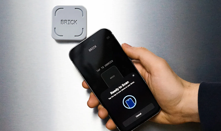 Photo of someone holding an iPhone with the Brick app reading reading to scan next to a Brick hardware puck