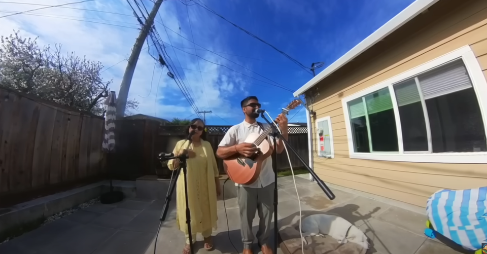 A photo of Avie Sheck and his mom singing in a backyard together.