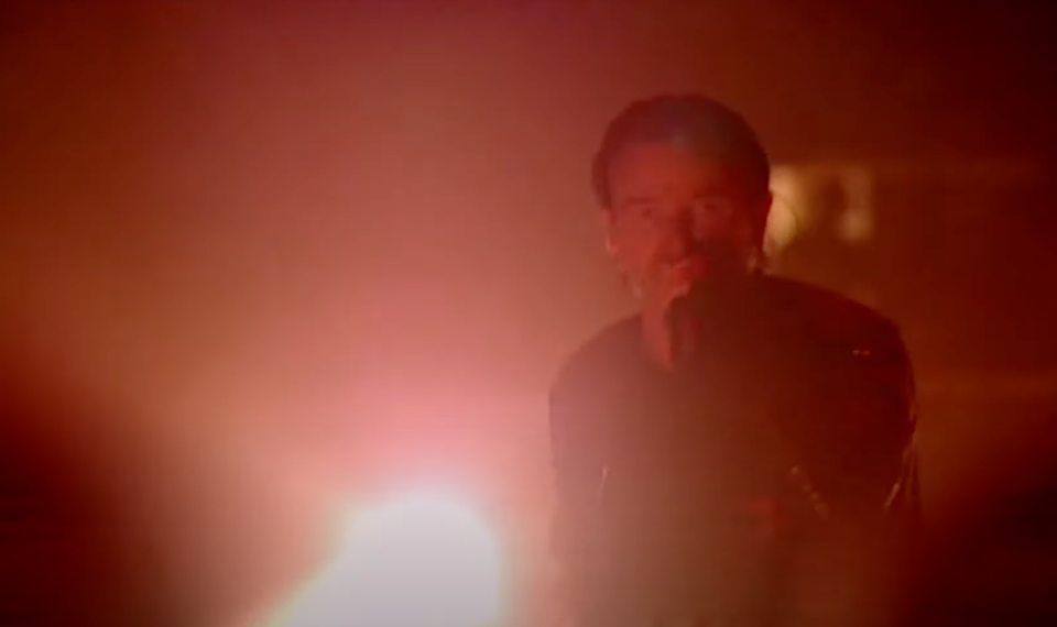 Bono holding a spotlight from the Bullet the Blue Sky live in Boston 2001 video