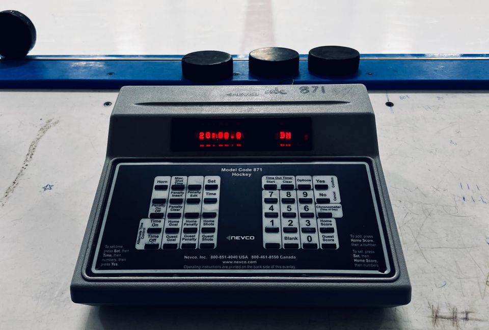 A photo of a hockey rink scoreboard control unit