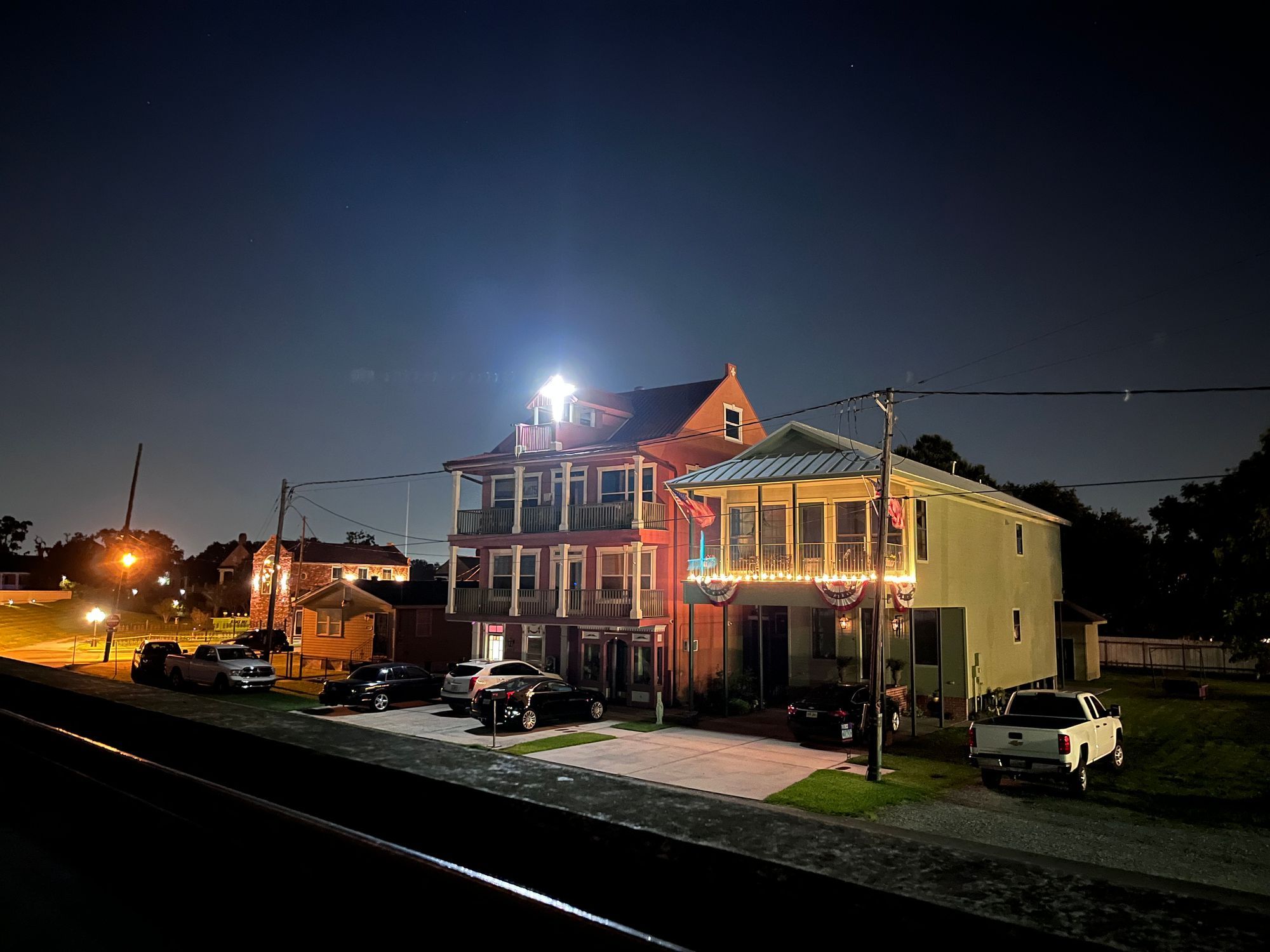 House with cross light shining at night
