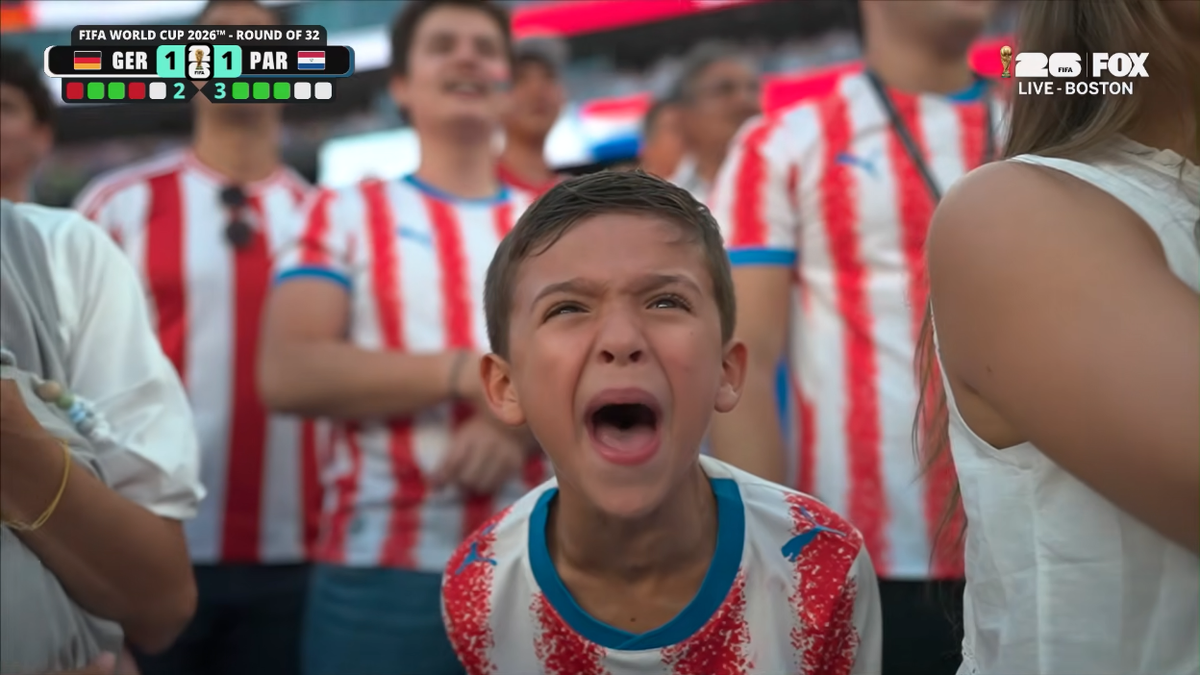 Child wearing a Paraguay jersey screams in support of his team at the World Cup