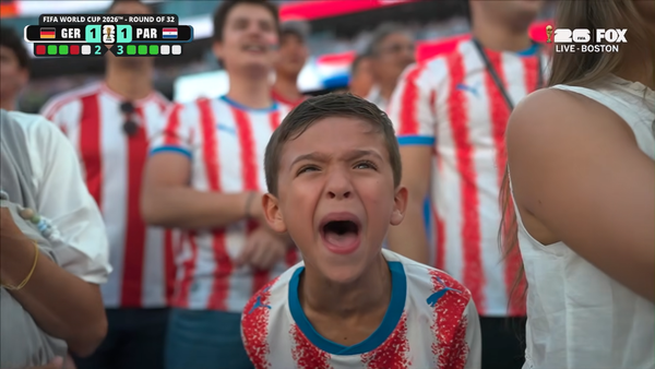 Child wearing a Paraguay jersey screams in support of his team at the World Cup