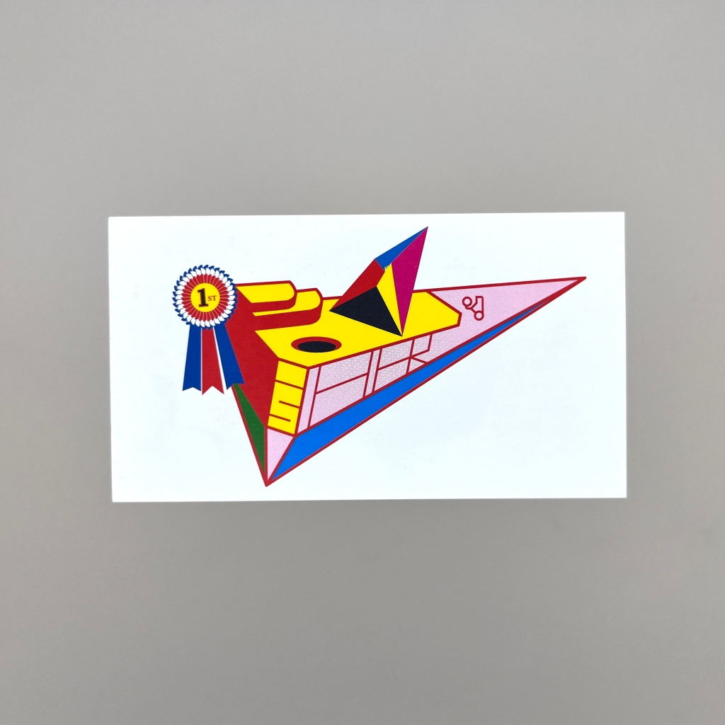 Back of business card with a brightly coloured simple illustration of what looks like a futuristic airplane or spaceship, with a 1st place rosette attached.