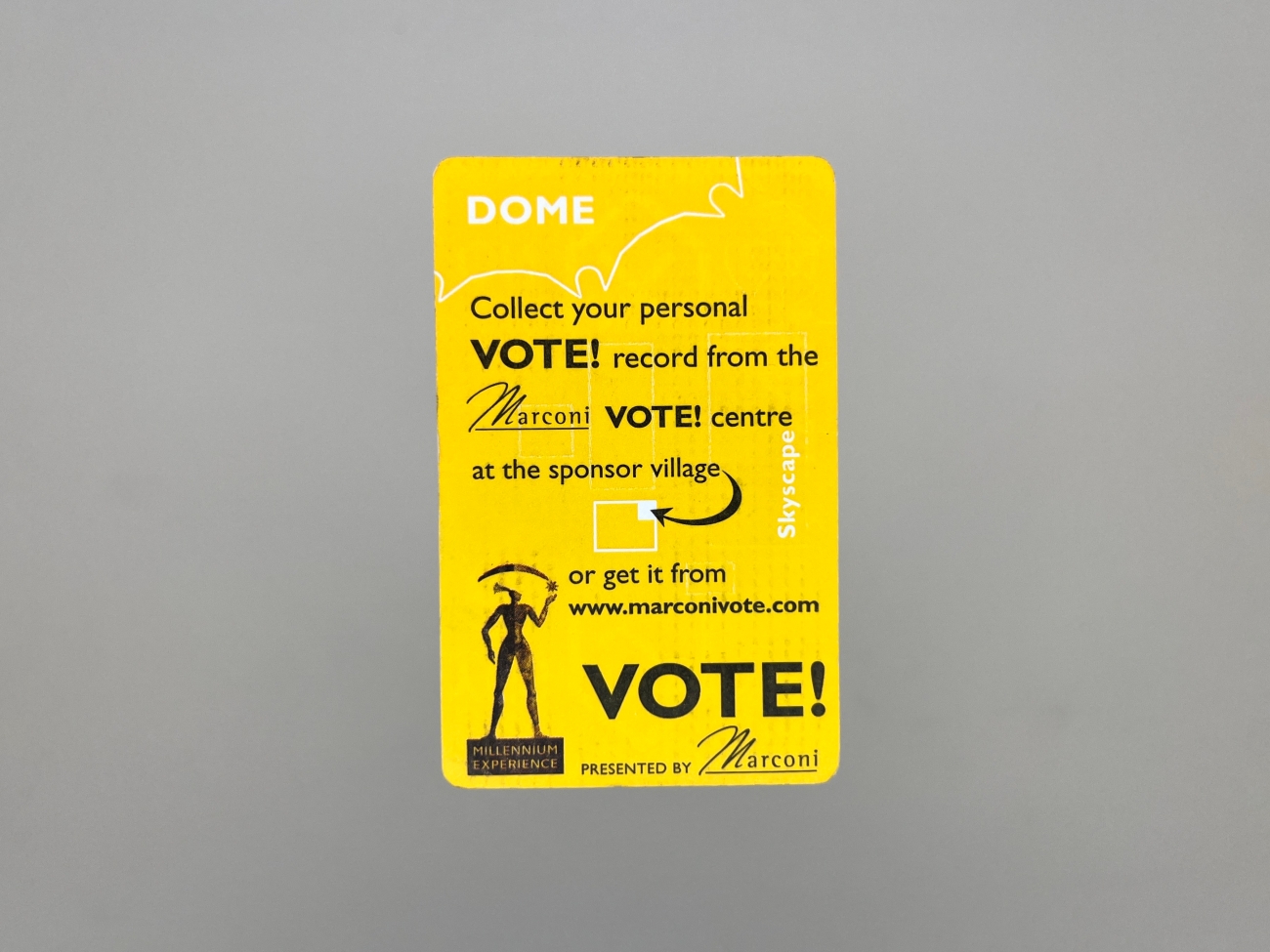 A vertical business card size piece of design with rounded corners, covered in bright yellow. It says DOME, Collect your personal VOTE! record from the Marconi VOTE! centre at the sponsor village or get it from marconivote.com