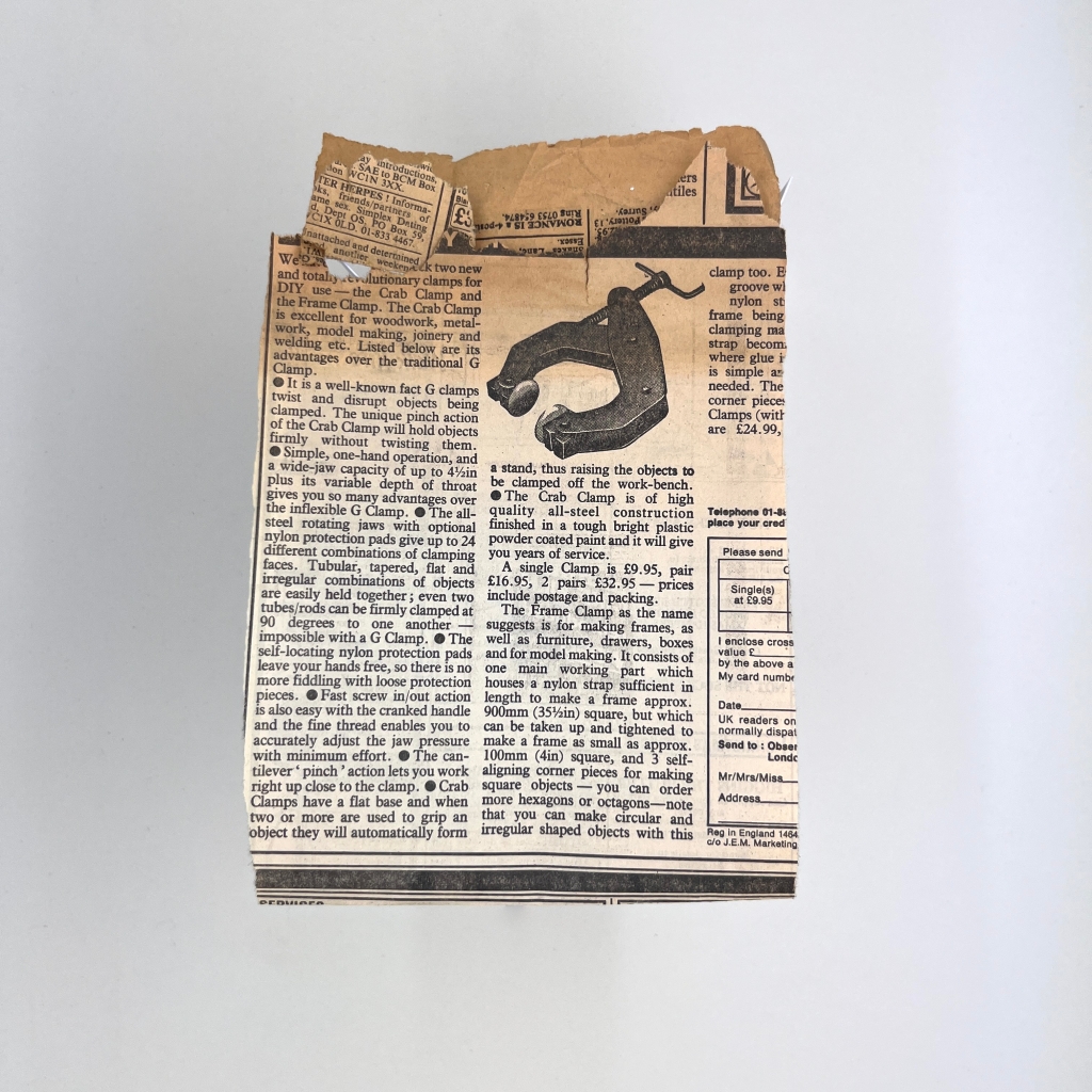 2 of 4 sides of and old piece of folded yellowing newspaper with classified adverts, with an illustration of a workbench clamp.