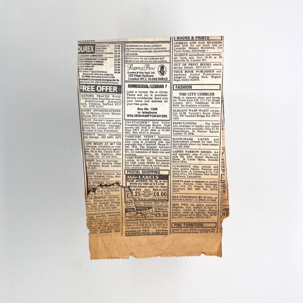 3 of 4 sides of and old piece of folded yellowing newspaper with classified adverts.