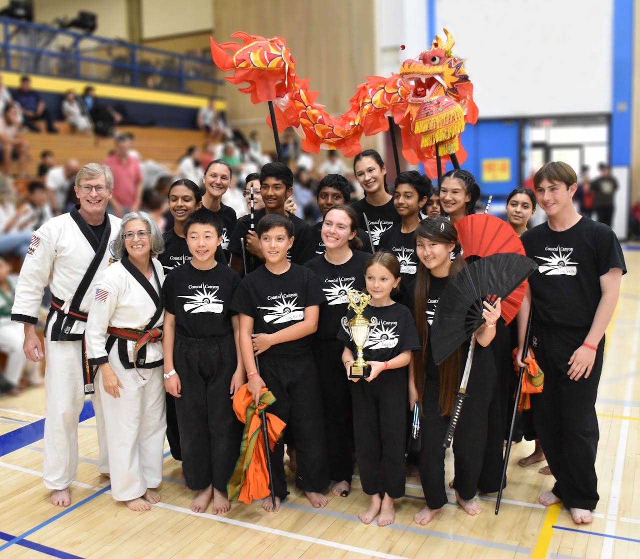 martial artists and a demonstration team pose for a photo