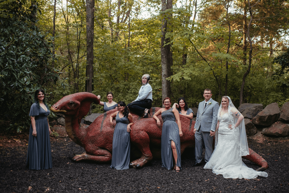 My wife and I, along with our wedding party on a dinosaur