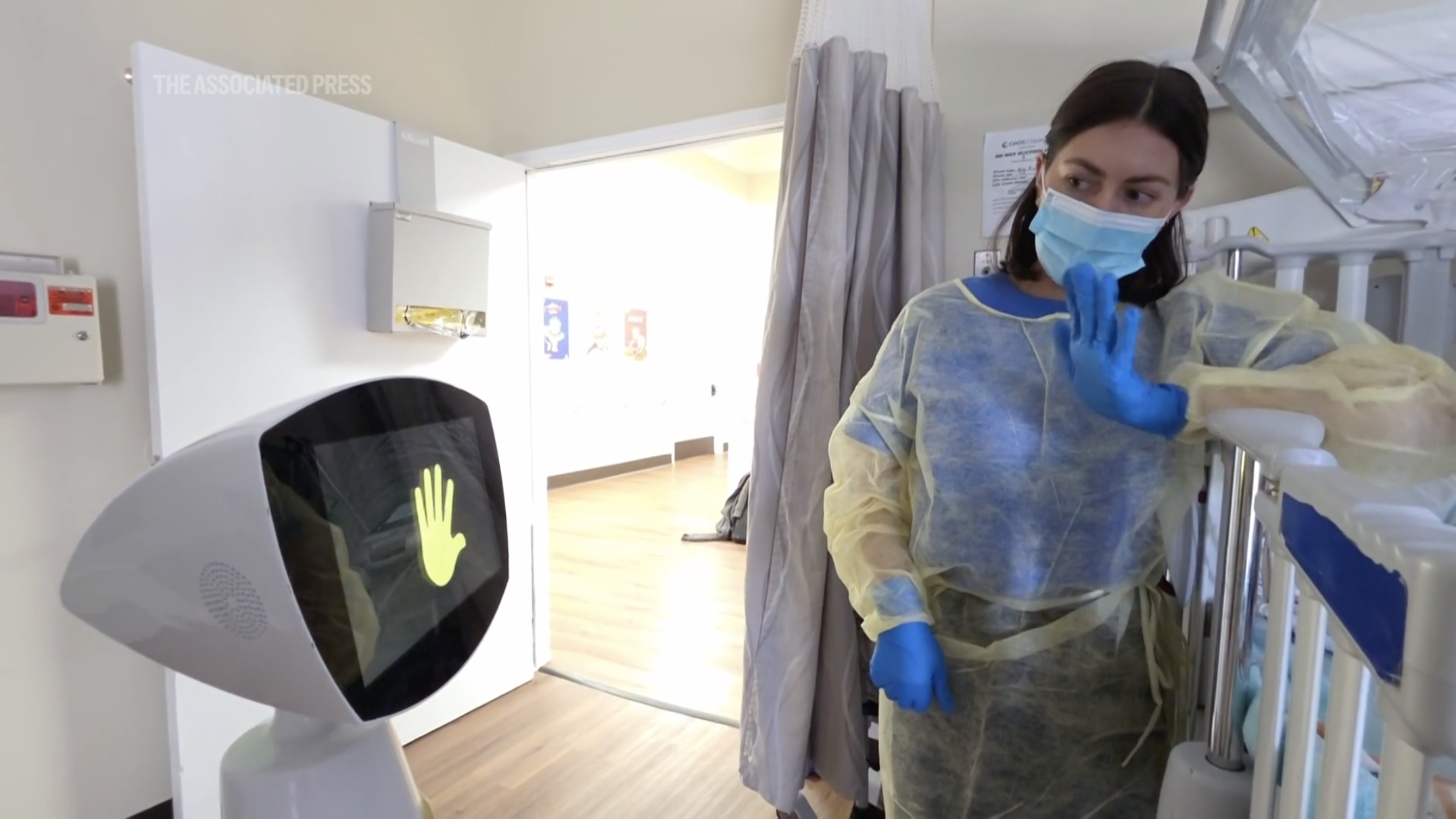 Nurse interacting with an AI-powered hospital robot used for pediatric patient engagement