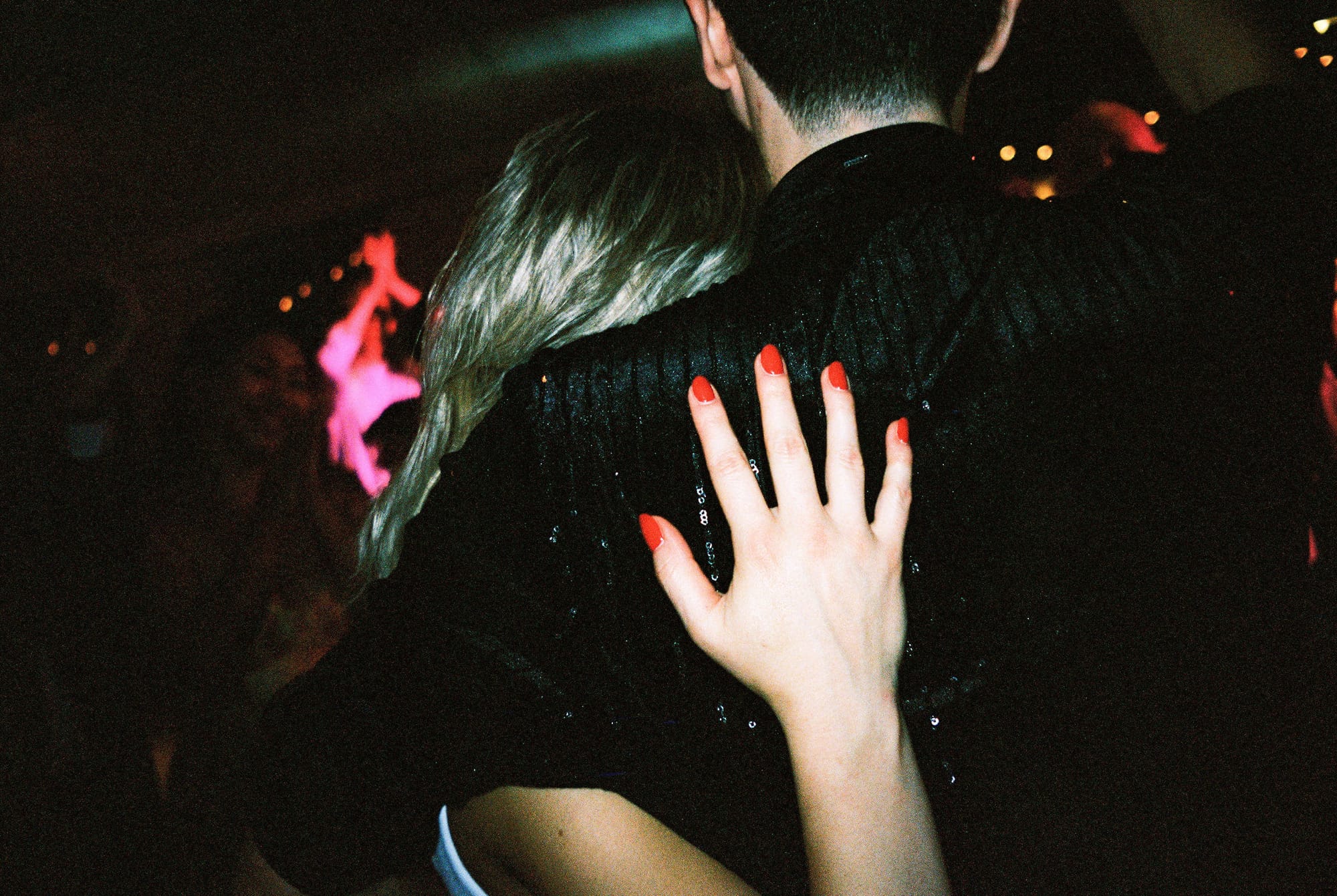 Hannah and Aaron at their reception, watching everyone on the dance floor, and taking it all in. 