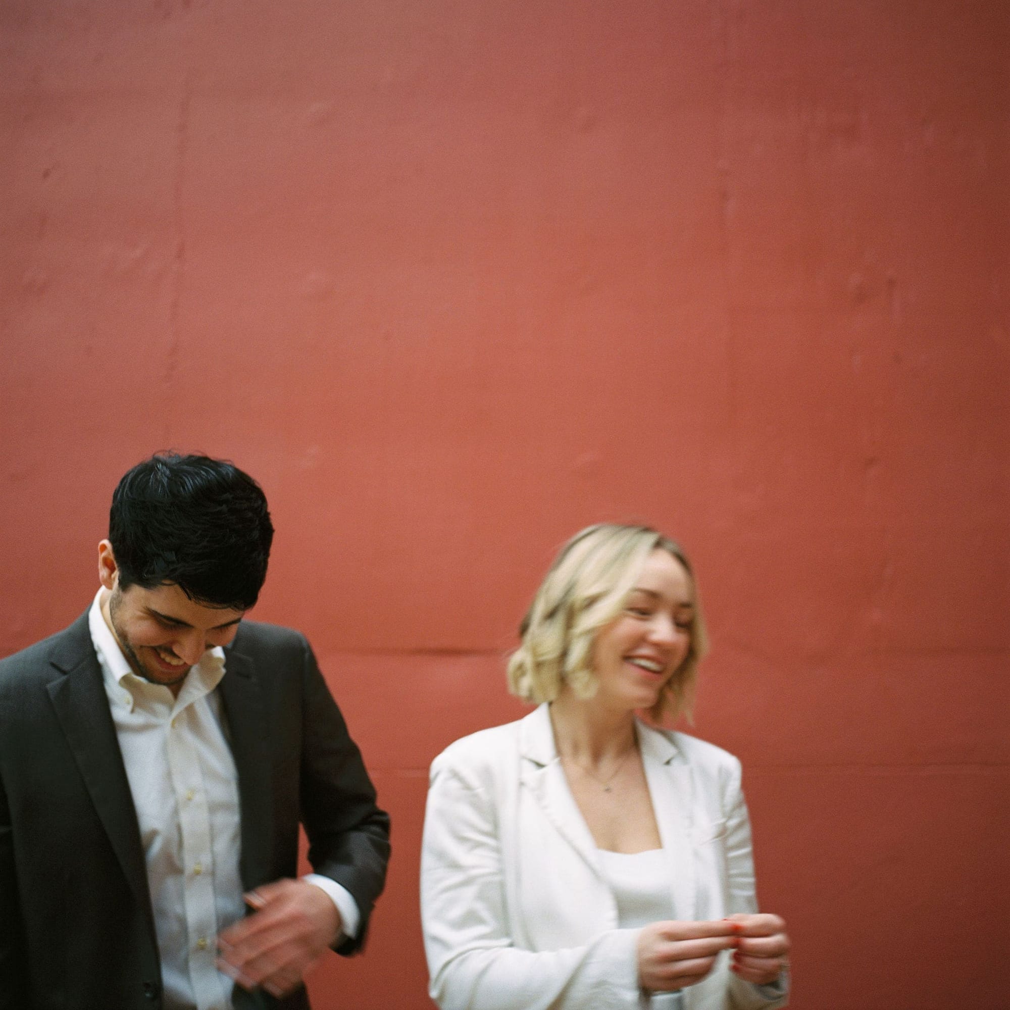 A couple laughing together during their engagement photo session.