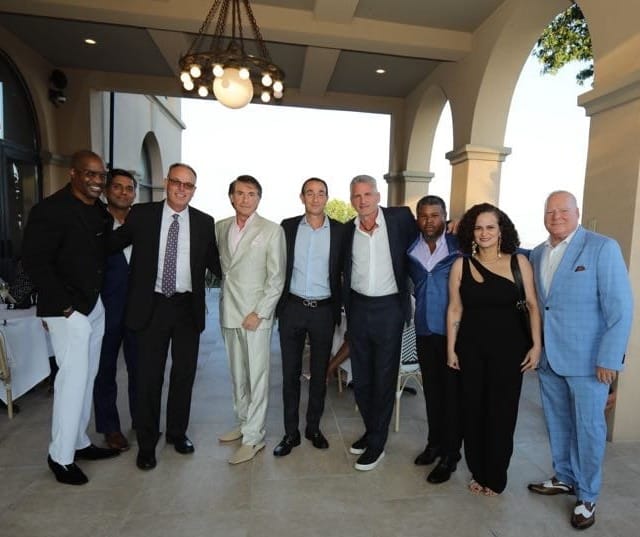J. Wayman Henry III and Margarita Duran pose with the CareWell Health Medical Center leadership team at Unity Table’s outdoor event.
