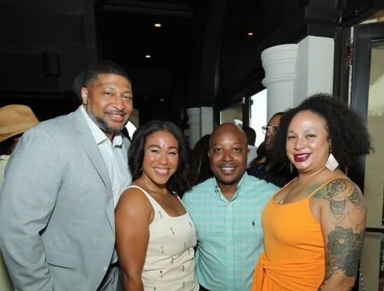 Talia L. Young poses with three guests at Unity Table’s The Symphony at Sunset event