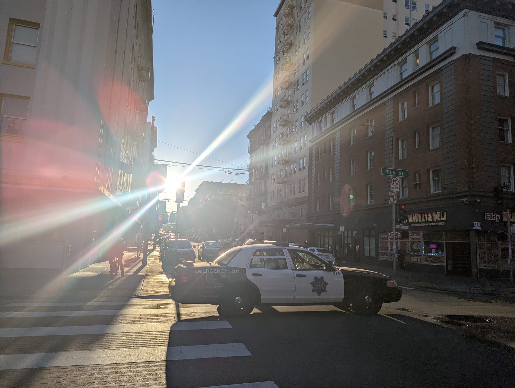A police vehicle passing through an intersection.