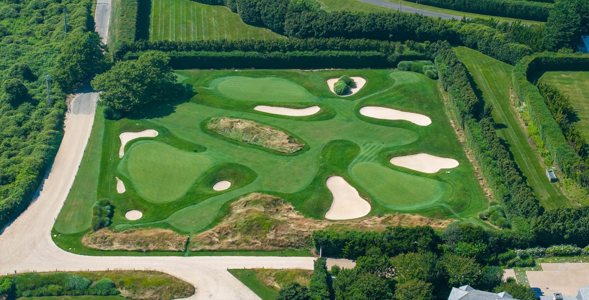 An overhead view of the private golf course at 407 Fairfield Pond Lane - Courtesy SERHANT. - Photographer: Josh Goetz