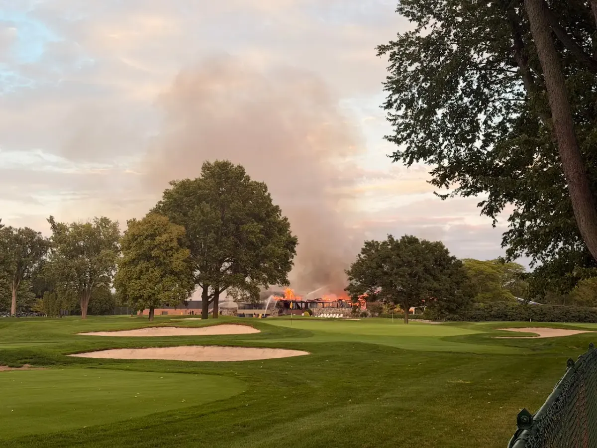 Lochmoor Club clubhouse in Grosse Pointe Woods, Michigan, fully involved in fire, viewed from the golf course