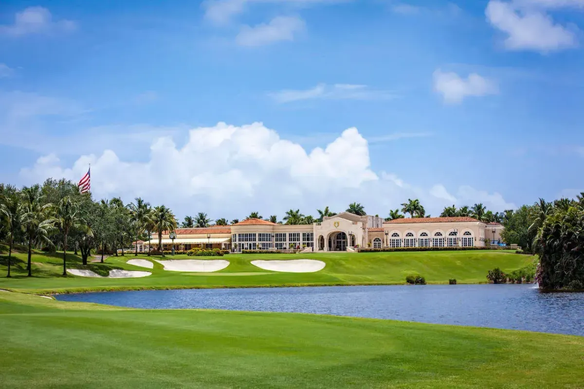 Mediterranean clubhouse at Trump International Golf Club in West Palm Beach, Florida, with course, bunkers, and water in the foreground