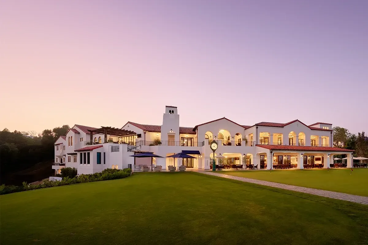 Bel-Air Country Club Spanish Colonial clubhouse exterior overlooking the golf course at dusk in Los Angeles