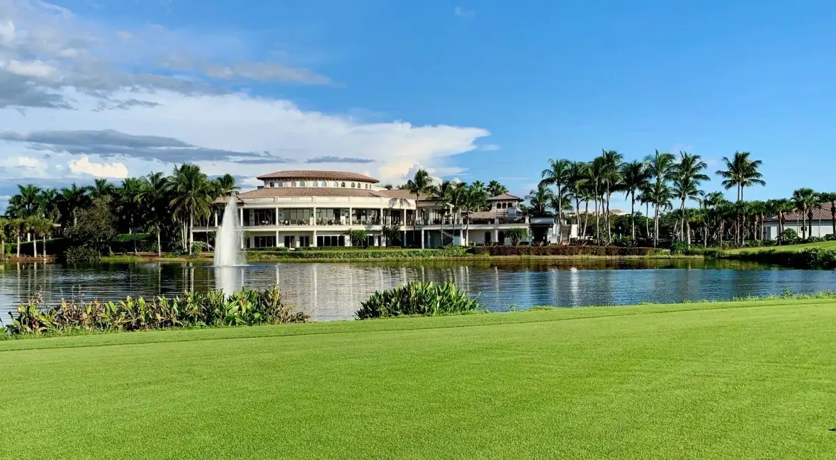 The Colony Golf & Country Club clubhouse exterior in Bonita Springs, Florida, across a water hazard with fountain