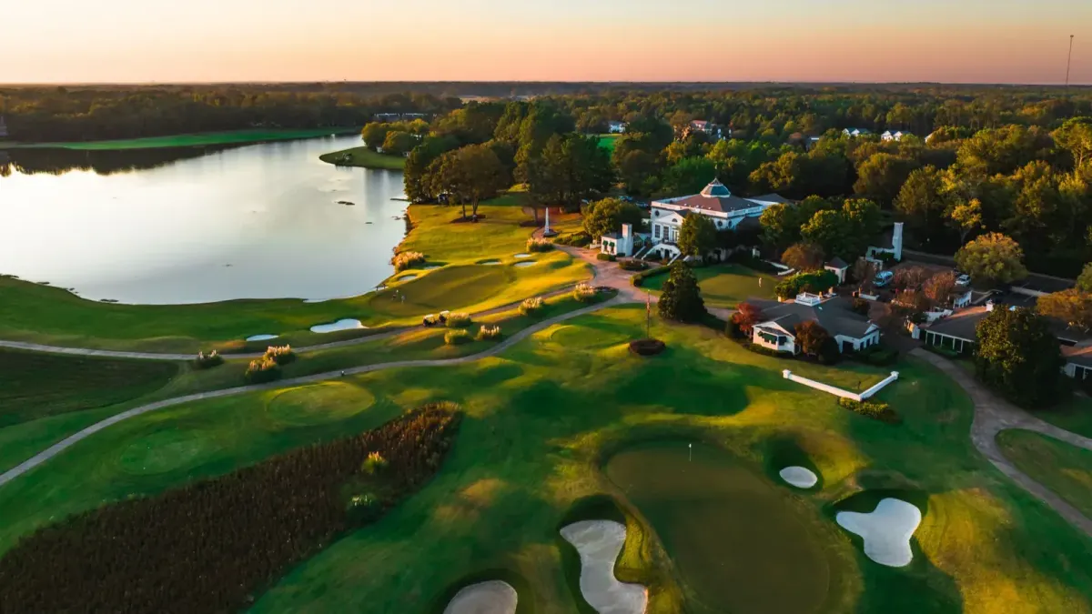 Aerial view of the Old Waverly clubhouse campus and golf course at sunset in West Point, Mississippi