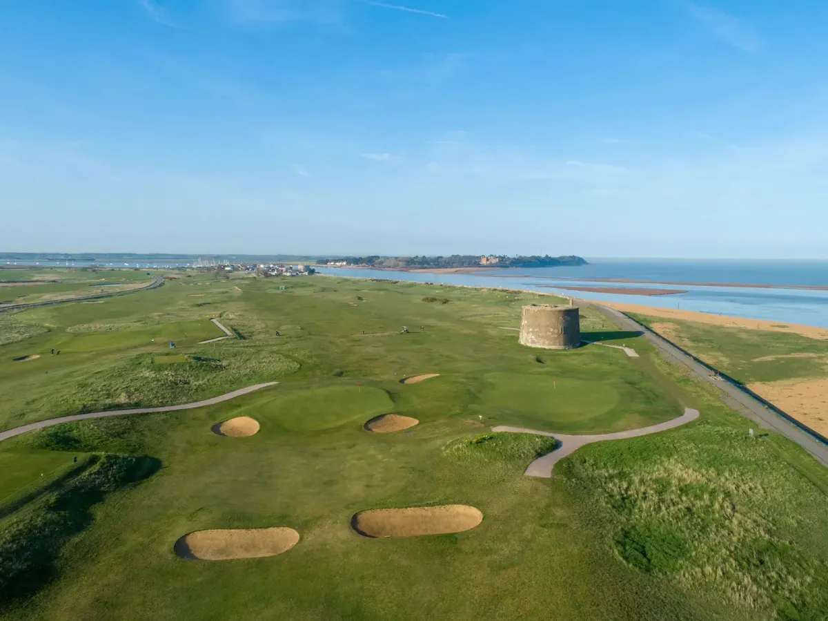 Aerial view of the links at Felixstowe Ferry Golf Club with a Martello tower and the Suffolk coastline in England