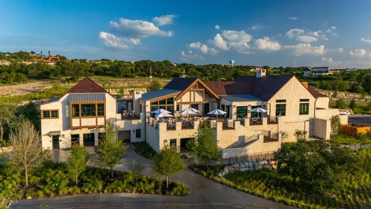 Summit Rock Clubhouse exterior at Horseshoe Bay Resort in Horseshoe Bay, Texas, with limestone walls and intersecting gables