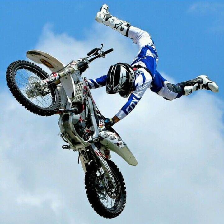 man lifting up off a motorbike on his hands - mid-air