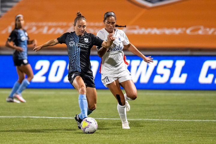 female footballers tackling on the field