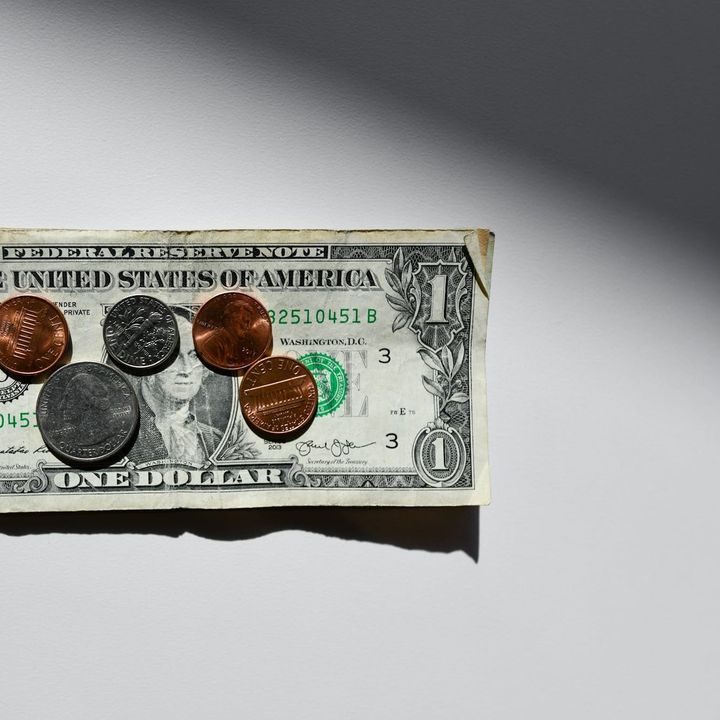 1$ bill and various coins