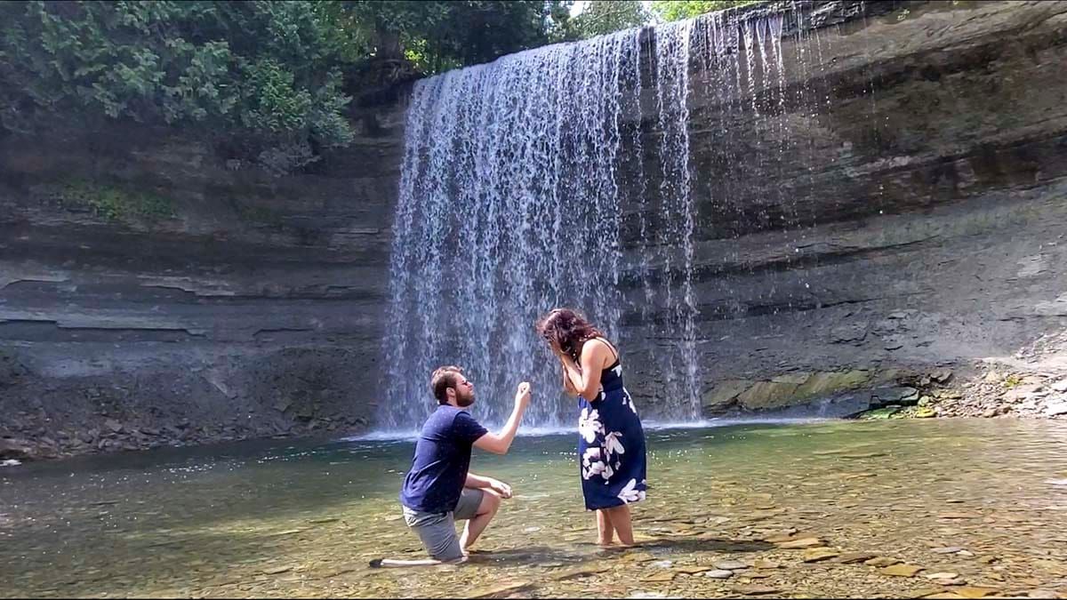Idyllic falls proposal captured by drone after helpful suitor rescues it from a cliff