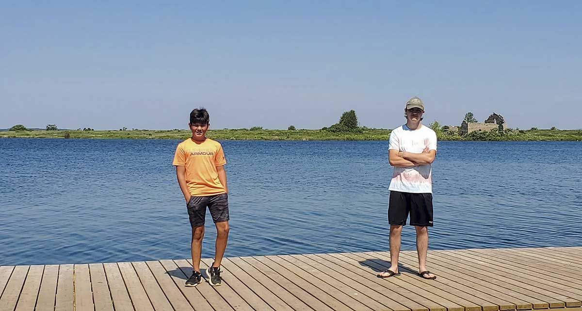 Three  youths work swiftly to rescue swimmer in distress