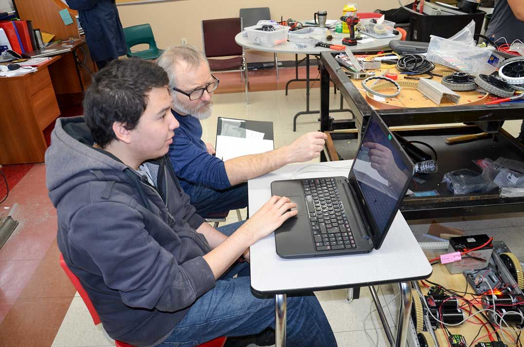 Wikwemikong FN-STEM robotics team working furiously down to the crunch